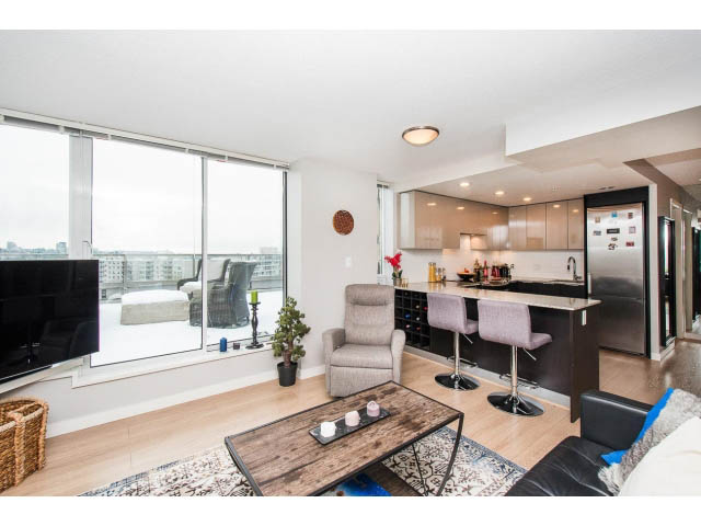 Bright living room with hardwood floors, city view, and modern furnishings. - 1110 - 445 West 2nd Ave, Vancouver West Side