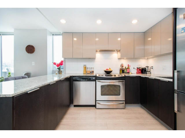 Bright kitchen with granite countertops, stainless steel appliances, and a city view. - 1110 - 445 West 2nd Ave, Vancouver West Side