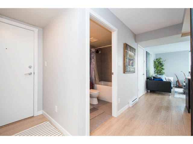 Furnished 1-bedroom entryway with hardwood floors and a modern door. - 1110 - 445 West 2nd Ave, Vancouver West Side