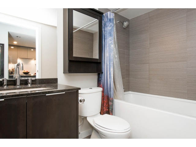 Bright bathroom with dark countertops and modern fixtures. - 1110 - 445 West 2nd Ave, Vancouver West Side