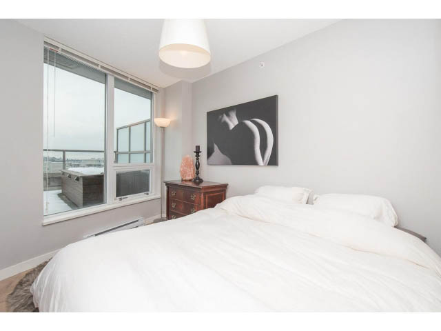 Bright bedroom with large window, city view, and modern decor. - 1110 - 445 West 2nd Ave, Vancouver West Side