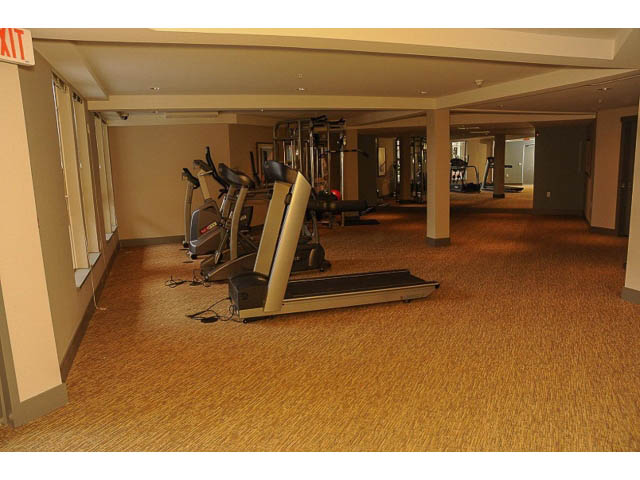 Spacious gym with cardio equipment and mirrors. - 311 - 159 West 22nd Street, North Vancouver