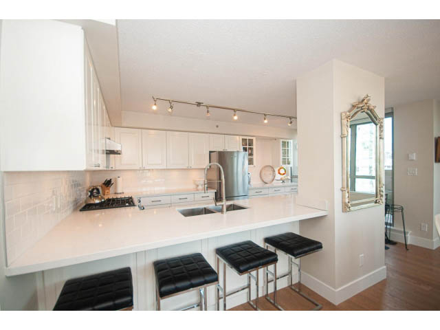 Bright kitchen with white cabinets, granite countertops, and hardwood floors. - 2204 - 1238 Richards Street, Vancouver Downtown