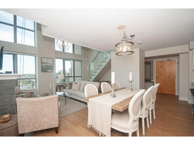 Bright dining area with hardwood floors, city view, and modern chandelier. - 2204 - 1238 Richards Street, Vancouver Downtown