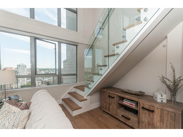 Bright loft bedroom with hardwood floors, city view, and modern staircase. - 2204 - 1238 Richards Street, Vancouver Downtown