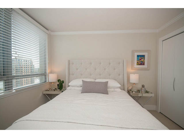 Bright and airy bedroom with a city view, white bedding, and modern decor. - 2204 - 1238 Richards Street, Vancouver Downtown