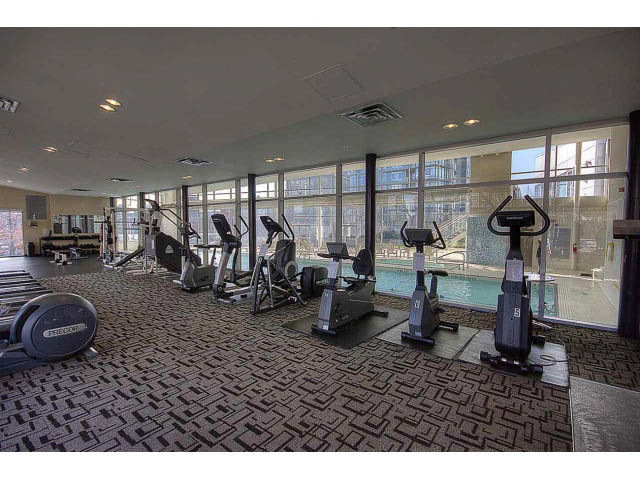Bright gym with large windows and city view, modern equipment. - 2005 - 1408 Strathmore Mews North West One, Vancouver Downtown