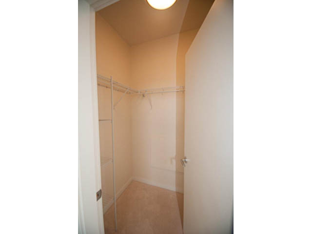 Bright walk-in closet with white walls and carpeted floor. - 402 - 625 East 3rd Street, North Vancouver