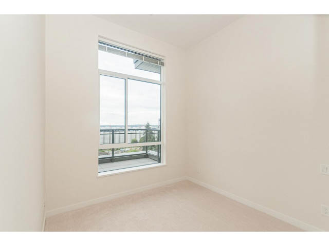 Bright living room with large windows and city view. - 402 - 625 East 3rd Street, North Vancouver