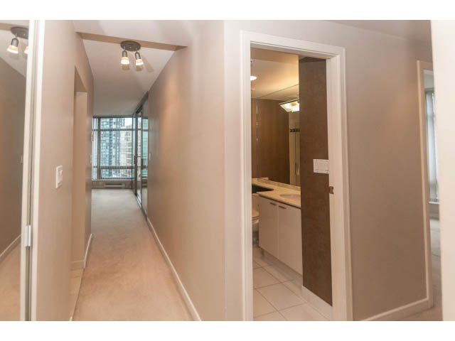Bright kitchen with white cabinets and a city view. - 1506 - 1200 Alberni Street, Vancouver Downtown