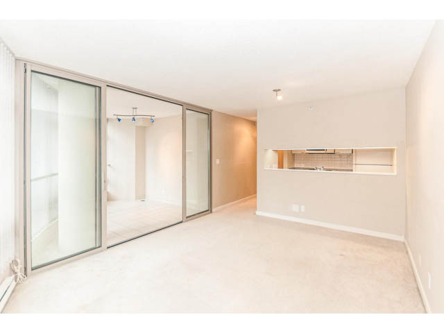 Bright living room with large windows and modern sliding glass doors. - 1506 - 1200 Alberni Street, Vancouver Downtown