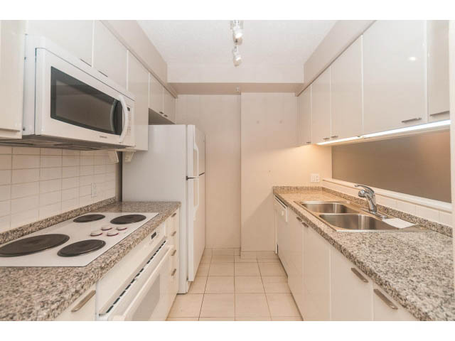 Bright kitchen with granite countertops, white cabinets, and a stainless steel sink. - 1506 - 1200 Alberni Street, Vancouver Downtown