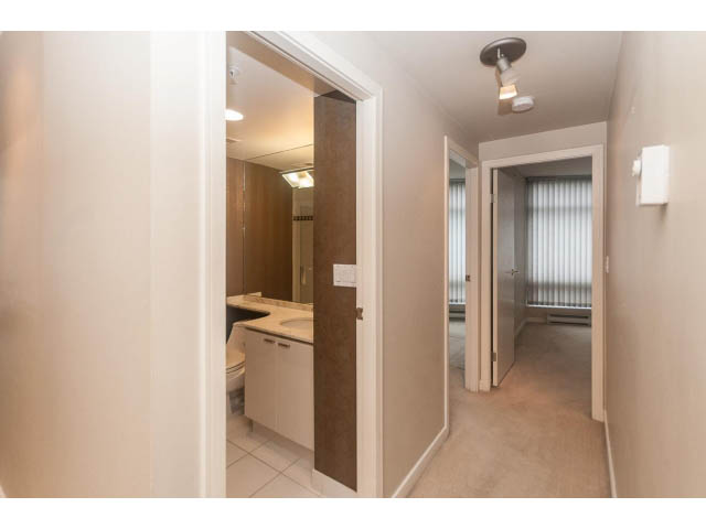 Bright living room with hardwood floors and a sliding door leading to a balcony. - 1506 - 1200 Alberni Street, Vancouver Downtown