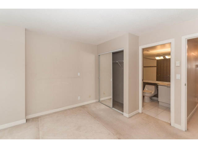 Bright living room with sliding closet doors and beige carpeting. - 1506 - 1200 Alberni Street, Vancouver Downtown
