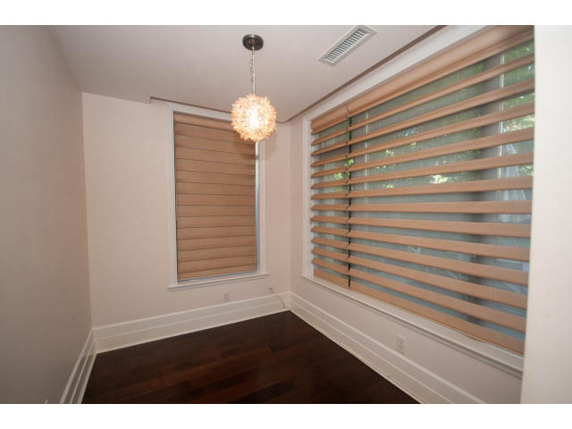 Bright living room with hardwood floors and large windows with blinds. - 104 - 533  Waters Edge Cres, West Vancouver