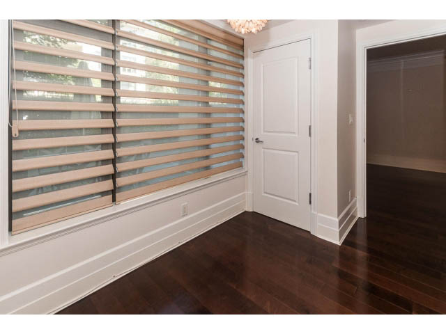 Bright living room with hardwood floors and large window with blinds. - 104 - 533  Waters Edge Cres, West Vancouver