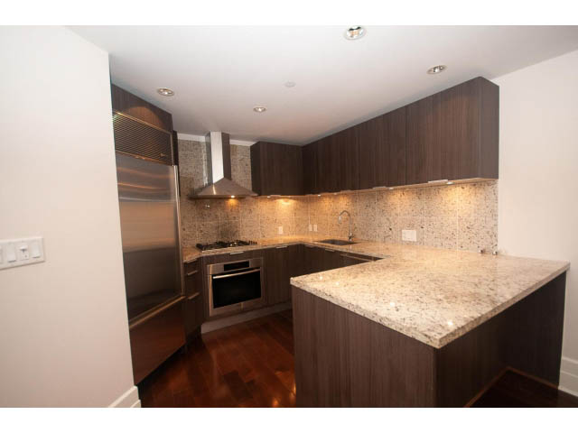 Bright kitchen with granite countertops, hardwood floors, and modern cabinetry. - 104 - 533  Waters Edge Cres, West Vancouver