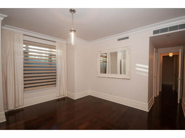 Bright living room with hardwood floors and large windows. - 104 - 533  Waters Edge Cres, West Vancouver