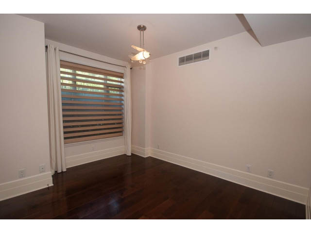 Bright living room with hardwood floors and a ceiling fan. - 104 - 533  Waters Edge Cres, West Vancouver