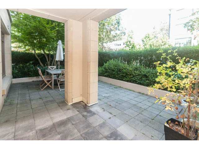 Furnished patio with stone flooring and greenery. - 104 - 533  Waters Edge Cres, West Vancouver