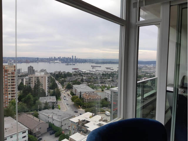 Bright living room with stunning city view and modern furnishings. - 1703 - 158 W 13th Street, North Vancouver