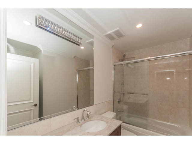Furnished bathroom with marble countertops and a walk-in shower. - Suite - 430 West Windsor Road, North Vancouver