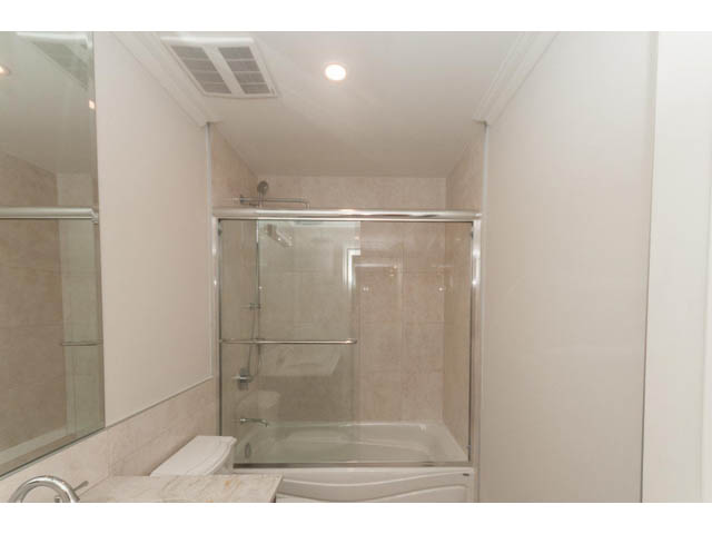 Furnished bathroom with marble countertop and glass shower. - Suite - 430 West Windsor Road, North Vancouver