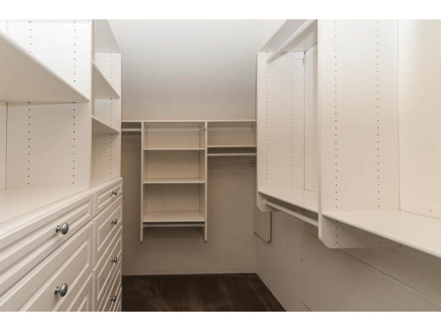 Spacious walk-in closet with built-in shelves and drawers, clean white finish. - 989 Forest Hills Drive, North Vancouver