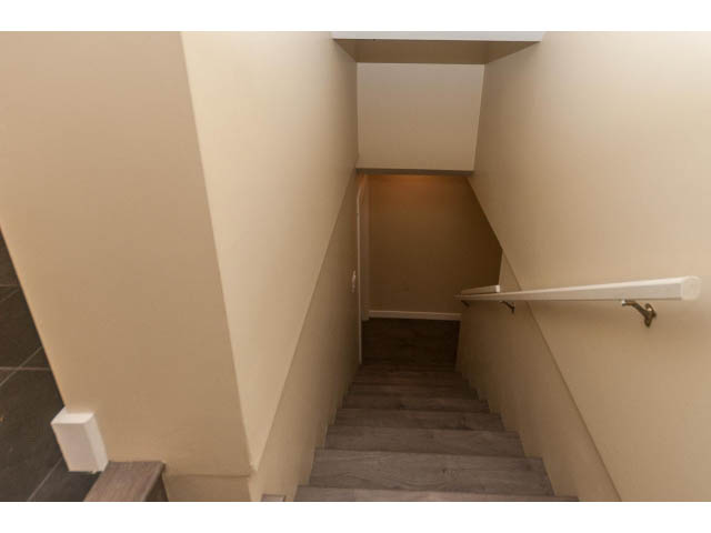 Staircase leading to upper floor with wooden steps and white walls. - 989 Forest Hills Drive, North Vancouver