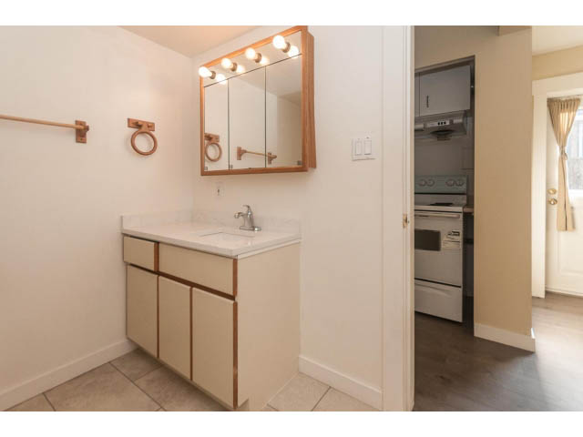 Bright bathroom with white vanity and modern light fixture. - 989 Forest Hills Drive, North Vancouver