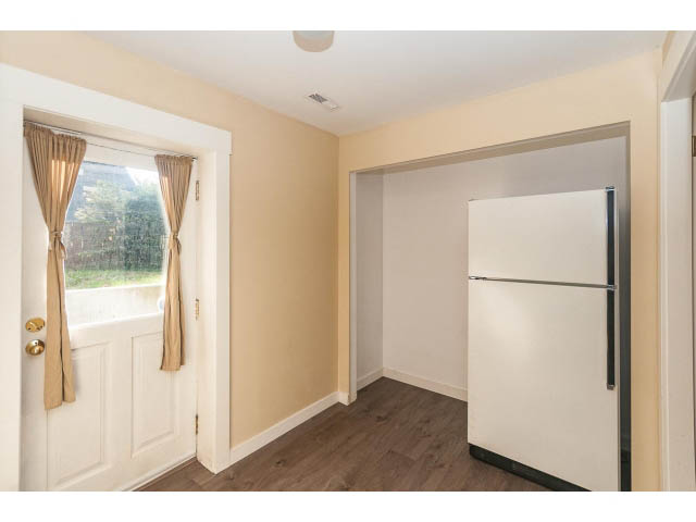 Bright kitchen with white cabinets and hardwood floors. - 989 Forest Hills Drive, North Vancouver