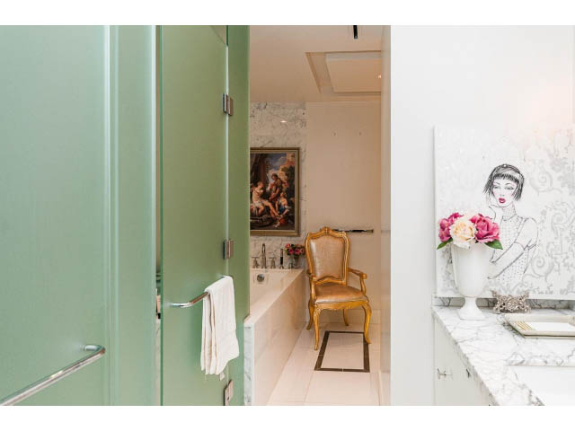 Bright bathroom with marble countertops and a gold-framed artwork. - 1602 - 667 Howe Street, Vancouver Downtown