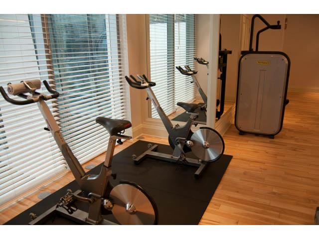 Bright gym with hardwood floors, exercise bikes, and large windows. - 1602 - 667 Howe Street, Vancouver Downtown