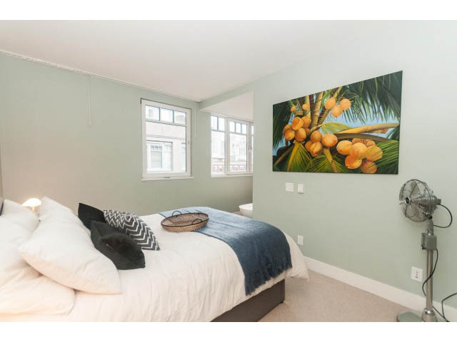 Bright bedroom with large windows, tropical artwork, and cozy bedding. - 501 - 1072 Hamilton Street, Vancouver Downtown