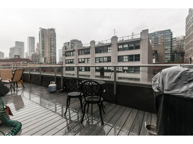 Furnished balcony with wet wooden deck, city view, and outdoor seating. - 501 - 1072 Hamilton Street, Vancouver Downtown