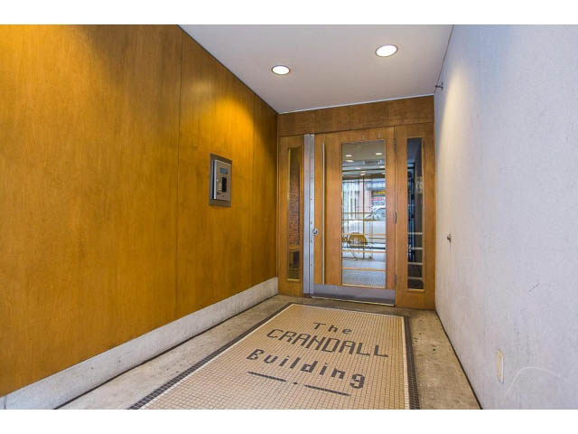 Foyer with wooden walls and tiled floor, leading to entrance. - 501 - 1072 Hamilton Street, Vancouver Downtown