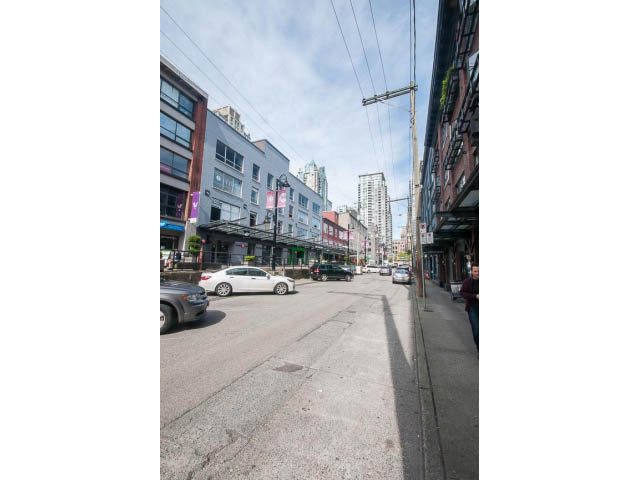 Furnished living room with city view and modern decor. - 501 - 1072 Hamilton Street, Vancouver Downtown