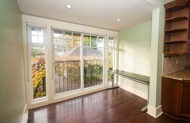 Bright kitchen with granite countertops, hardwood floors, and a view of the backyard. - 196 W 18th Avenue, Vancouver West Side