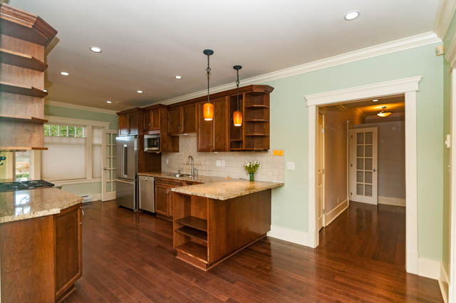 Bright kitchen with granite countertops, hardwood floors, and a view into a living area. - 196 W 18th Avenue, Vancouver West Side