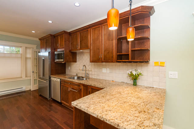 Bright kitchen with granite countertops, hardwood floors, and pendant lighting. - 196 W 18th Avenue, Vancouver West Side