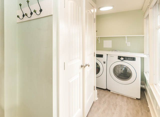 Shared laundry room with white appliances and wooden flooring. - 196 W 18th Avenue, Vancouver West Side