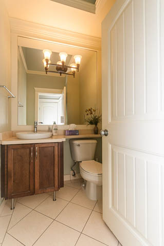 Furnished bathroom with wooden cabinets and a white toilet. - 196 W 18th Avenue, Vancouver West Side