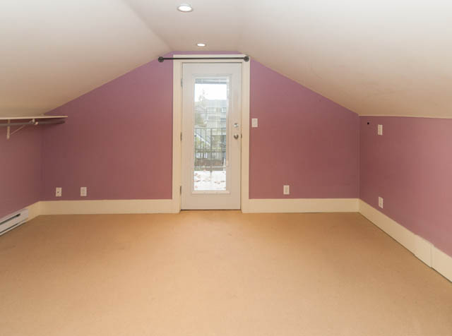 Attic room with sloped ceiling and small window, ready for conversion. - 196 W 18th Avenue, Vancouver West Side