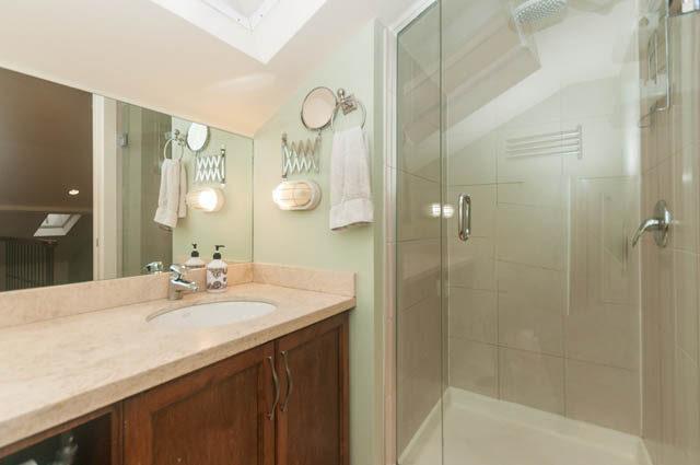 Furnished bathroom with marble countertops and a glass shower. - 196 W 18th Avenue, Vancouver West Side