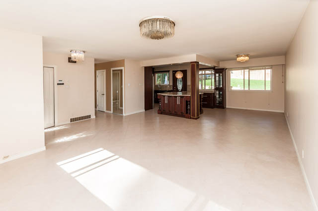 Open living space with hardwood floors and a chandelier. - UPPER - 630 East 29th Street, North Vancouver