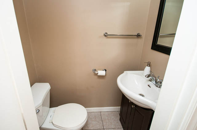 Small bathroom with white fixtures and beige walls. - UPPER - 630 East 29th Street, North Vancouver
