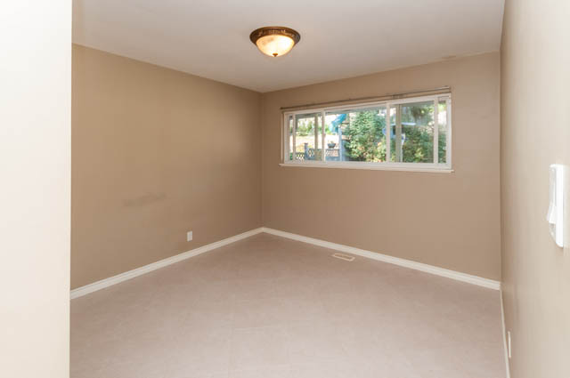 Bright living room with large window, neutral walls, and recessed lighting. - UPPER - 630 East 29th Street, North Vancouver