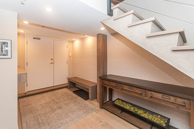 Furnished living area with wooden accents and modern staircase. - PH7 - 1688 Robson Street, Vancouver Downtown