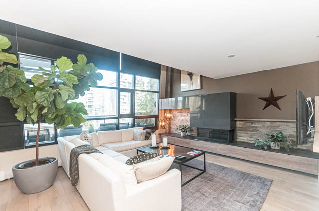 Bright living room with hardwood floors, city view, and modern furnishings. - PH7 - 1688 Robson Street, Vancouver Downtown