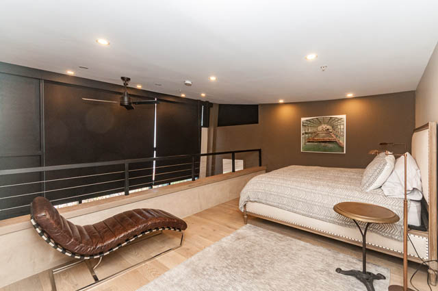 Spacious penthouse living room with modern furniture, large TV, and wooden flooring. - PH7 - 1688 Robson Street, Vancouver Downtown